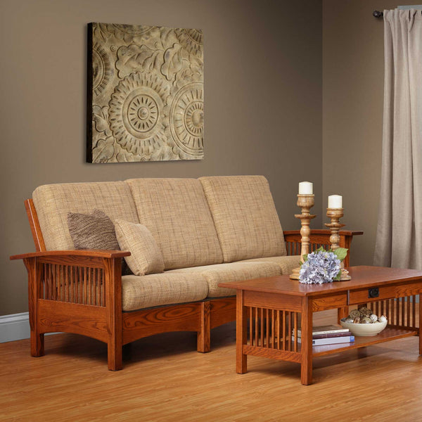Oak Mission Morris sofa with tan tweed cushions and slat sides beside a slat side coffee table and candlesticks