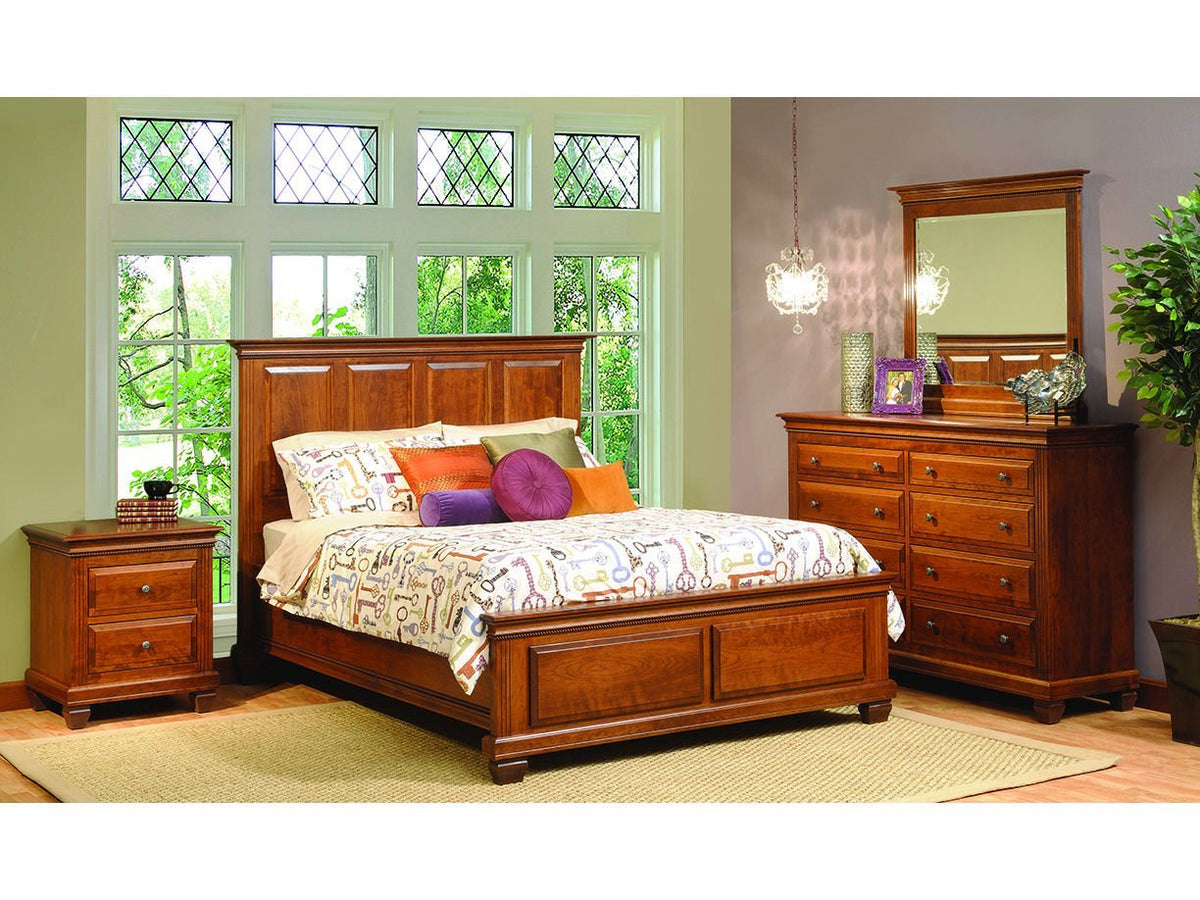 Cherry Palatine bedroom set staged on a woven rug with panel bed, eight-drawer dresser, tall mirror and two-drawer nightstand