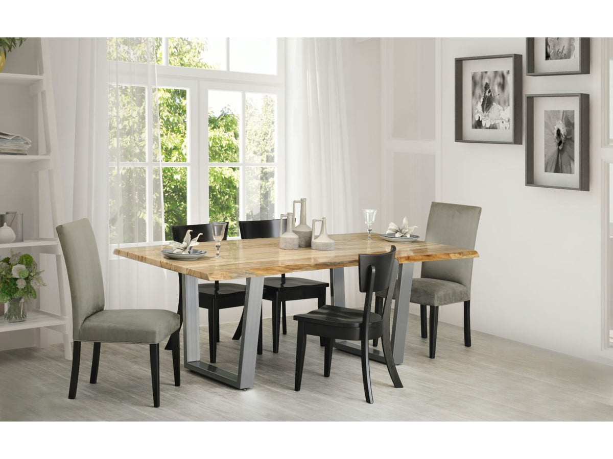 Bright dining room with a live edge dining table on silver metal legs, gray upholstered chairs and black wood side chairs