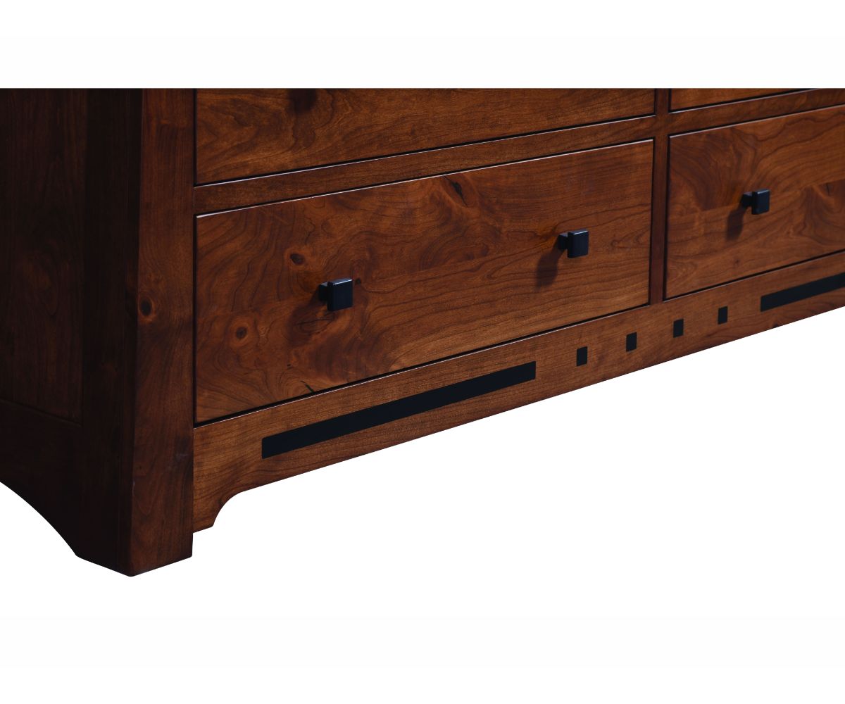 Close-up of the Van Nuys dresser base showing figured cherry drawer fronts, black square knobs and inset ebony strip and square inlays