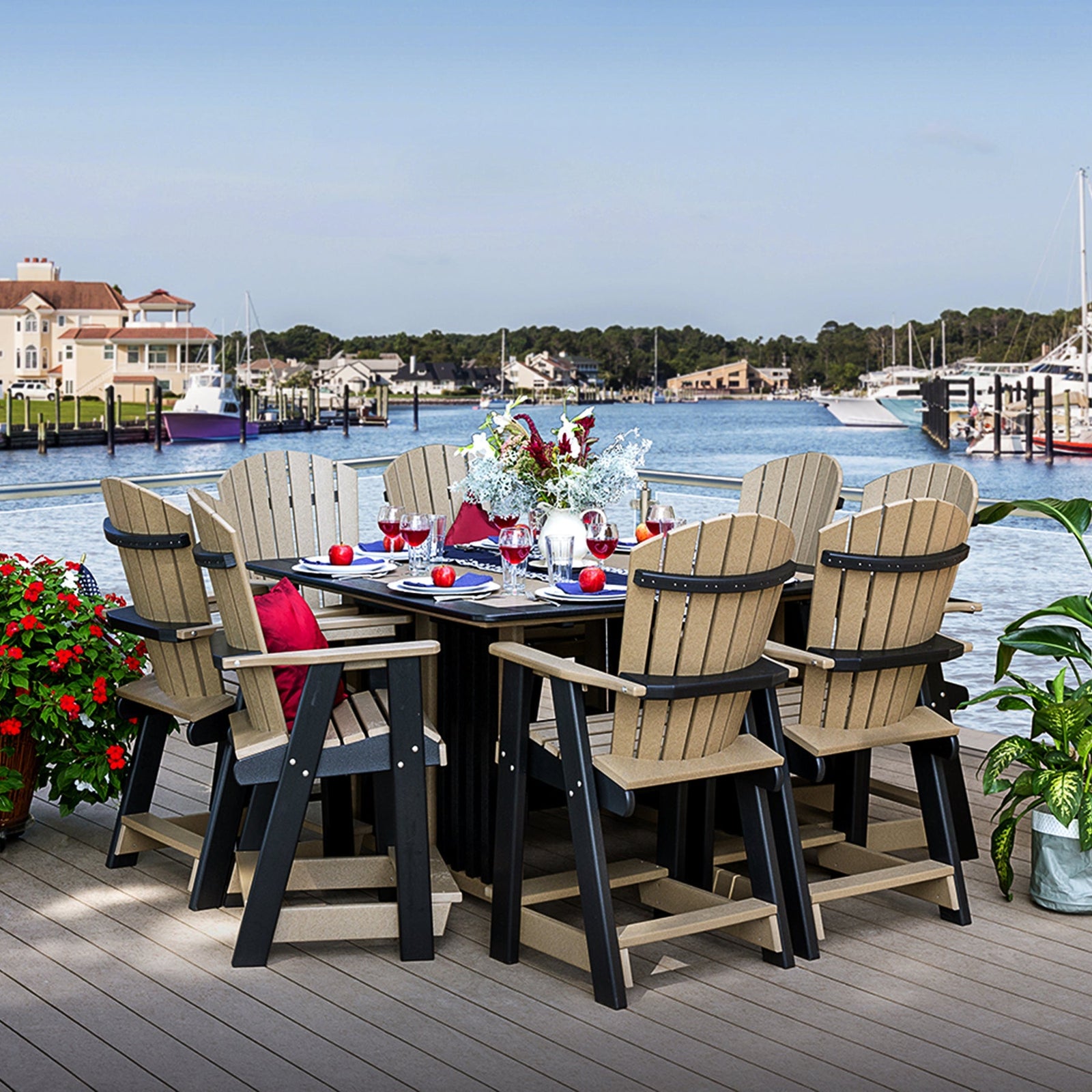 Weathered wood and black poly bar height table set with six fanback swivel chairs on a marina waterfront deck