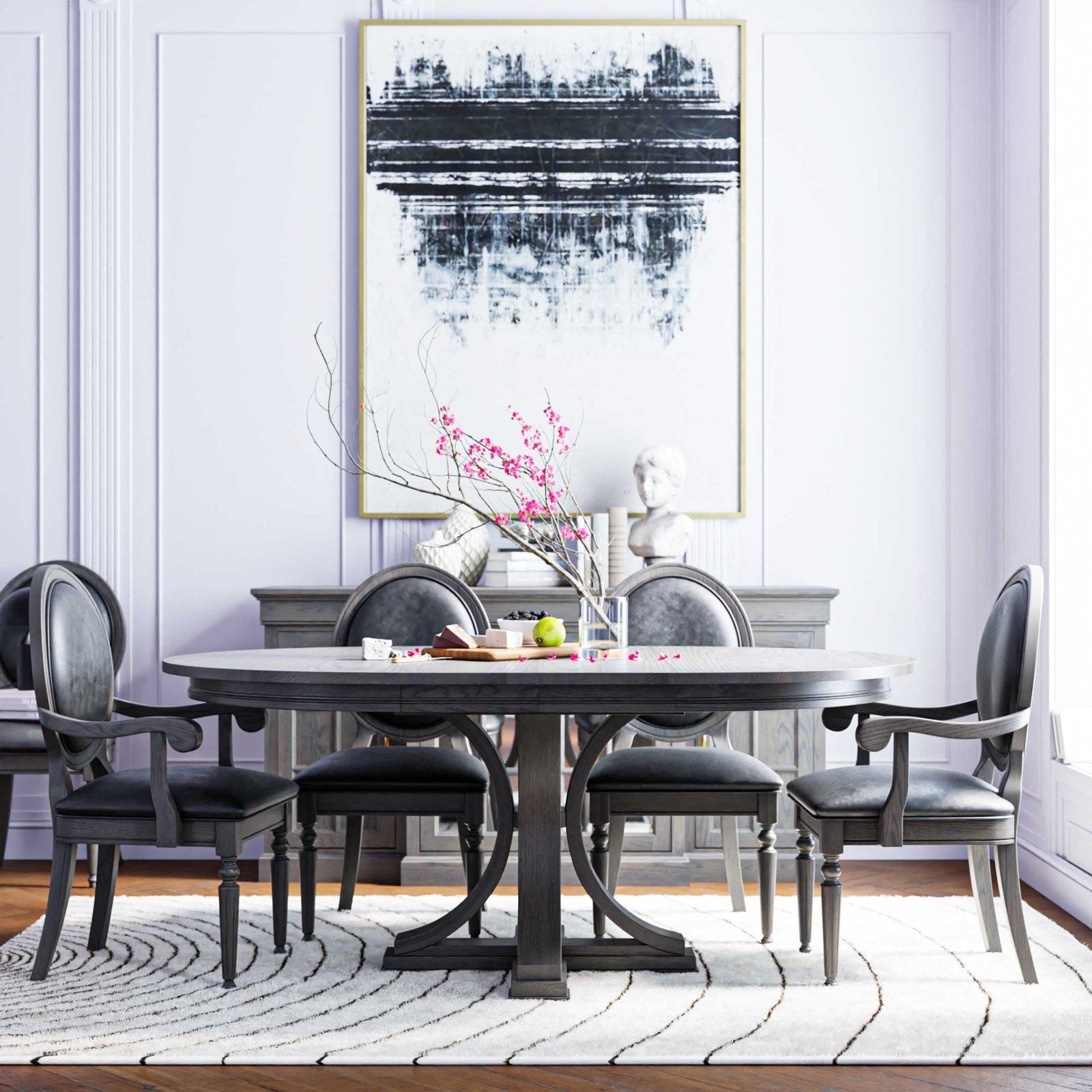 Oval double pedestal dining table in gray with curved base, round back leather chairs and abstract art in a bright room