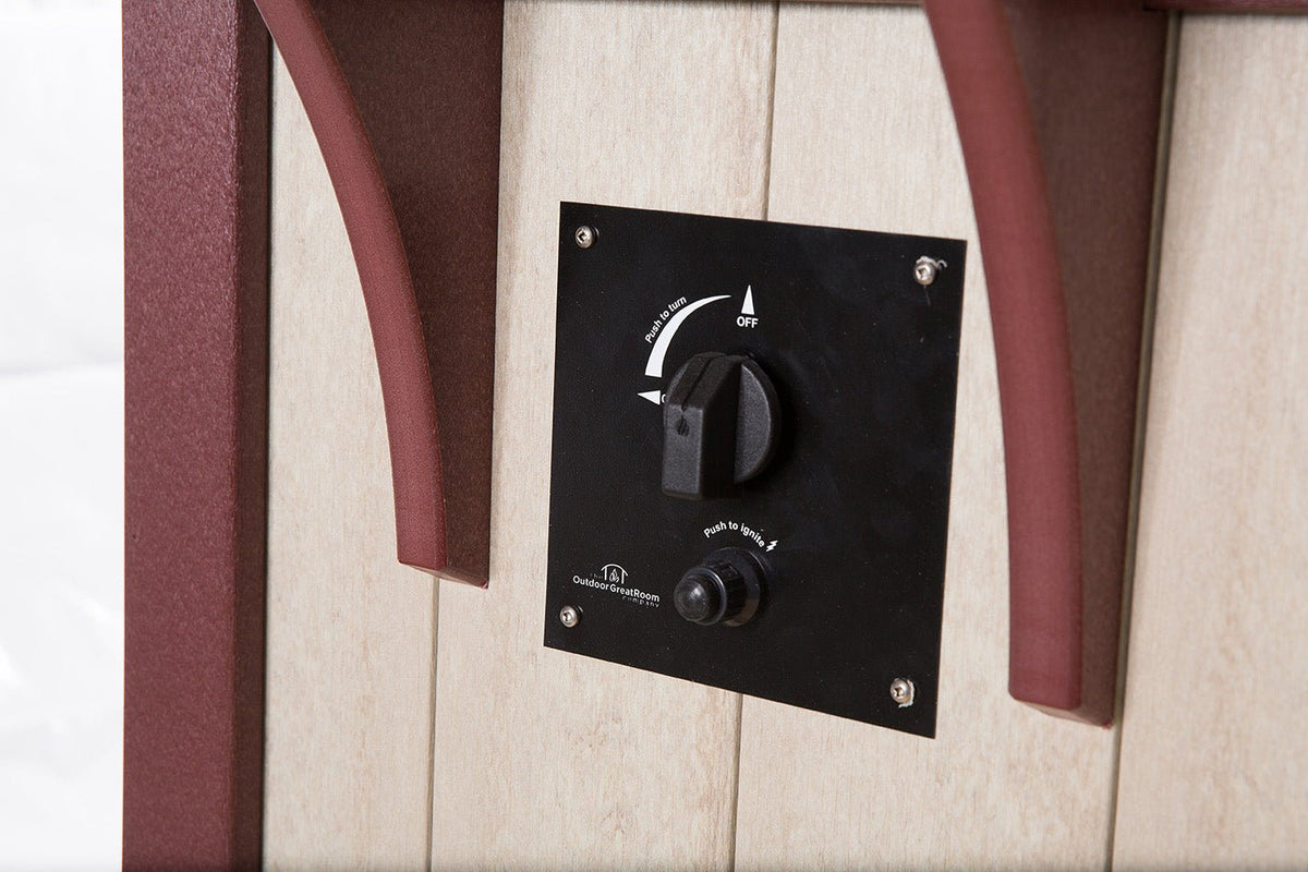 Black gas control panel with knob and igniter mounted on the cream and cherry side of a poly fire bar