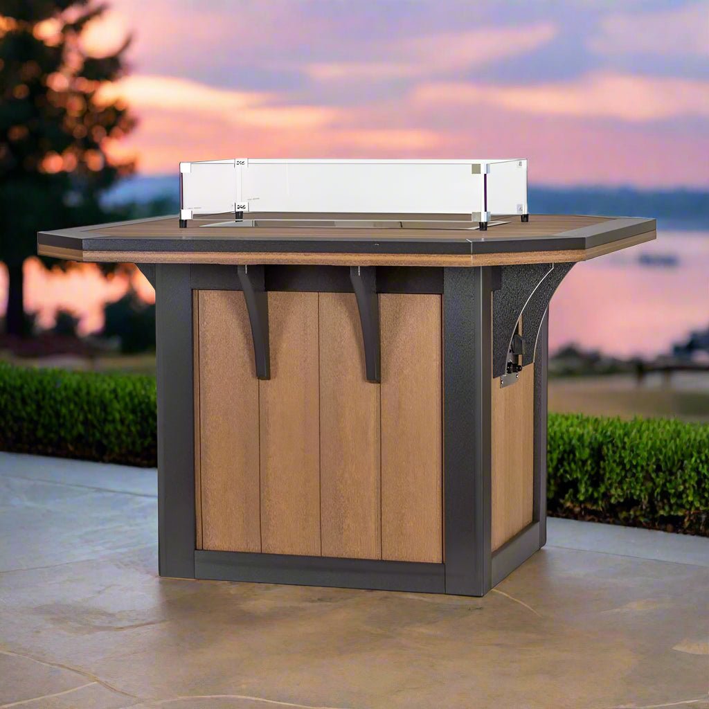 Cedar poly square fire pit dining table with black frame, clipped corners and a rectangular glass flame guard on a lakeside patio at sunset