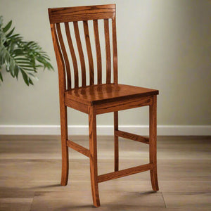 Oak counter height bar chair with a curved crest rail, five vertical back slats and a solid seat, on wood flooring