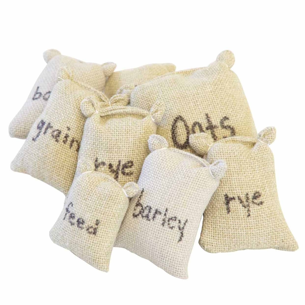 Set of miniature burlap toy feed sacks labeled grain, oats, rye, barley and feed for wooden farm play