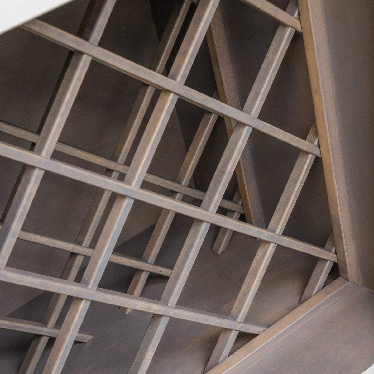 Close-up of the sideboard's solid wood diagonal wine rack lattice in a gray stain