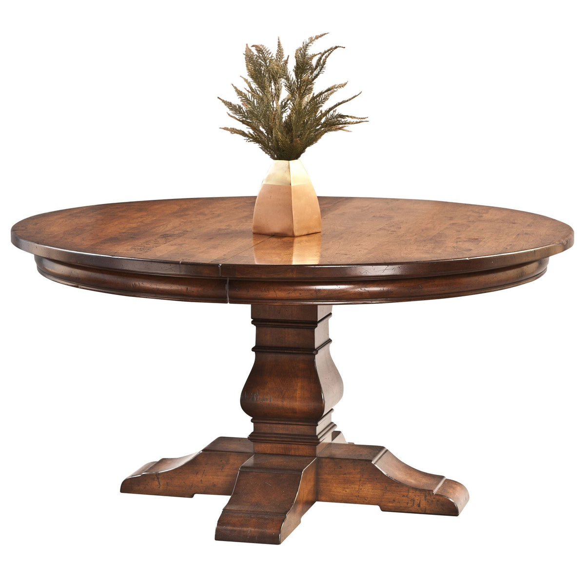 Round expandable pedestal dining table in rustic cherry with a turned column and four scrolled feet