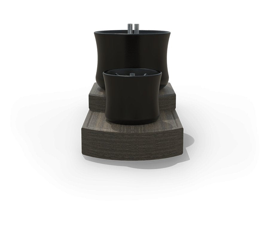 End view of the tabletop fire feature showing the stepped gray poly base and two black ceramic burner bowls
