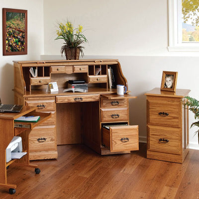 Oak roll top desk in a bright home office with open cubbies, file drawer out and a matching file cabinet nearby
