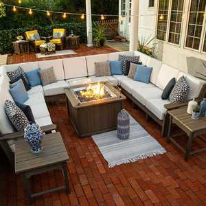 Overhead view of a nine seat U shaped patio sectional with white cushions circling a rectangular gas fire pit table