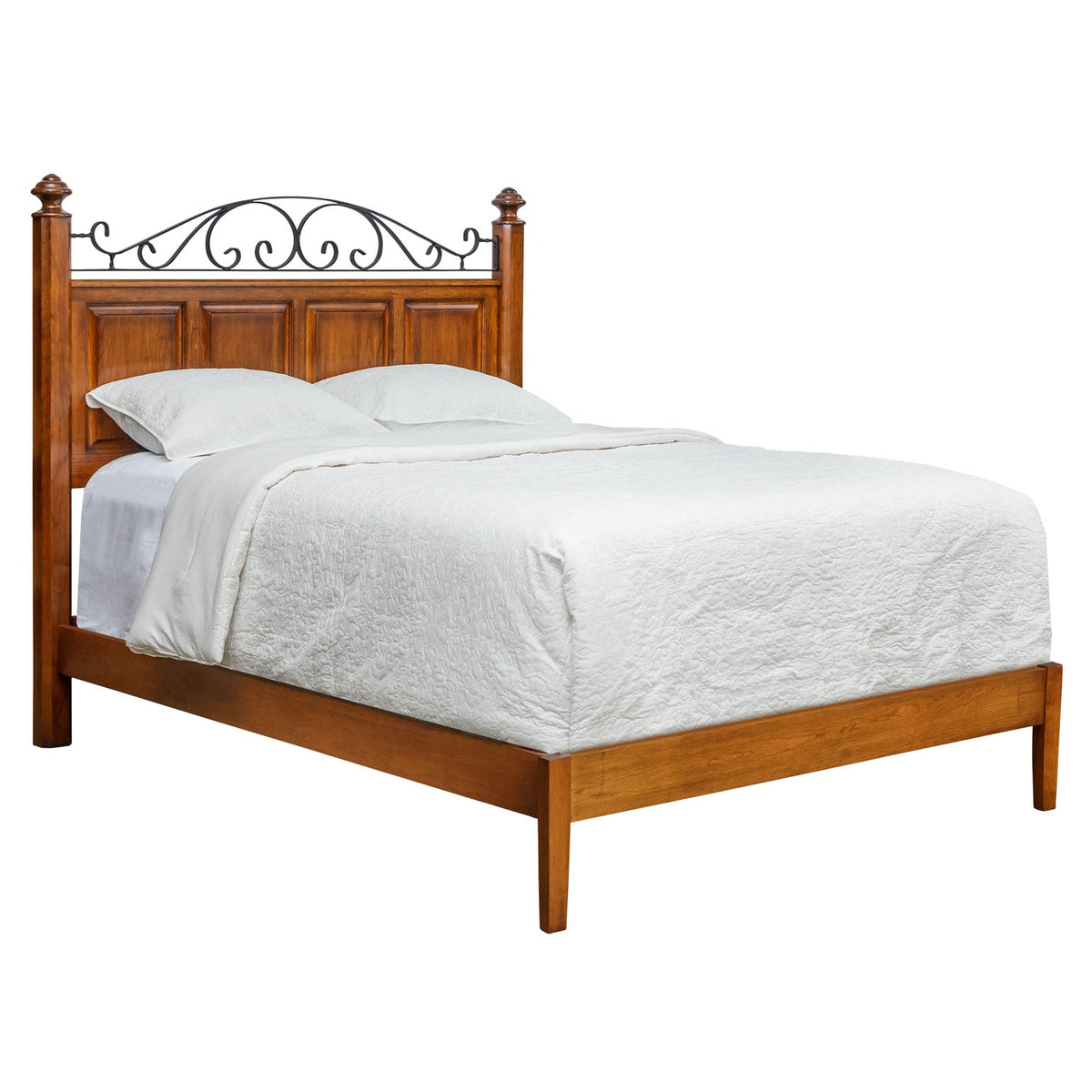 Cherry headboard with black iron scrollwork above raised panels on a low profile bed with white bedding