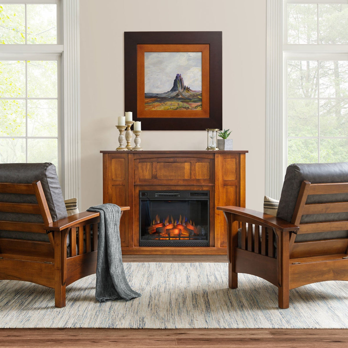 Cherry fireplace mantel with a glowing electric heater flanked by two Mission slat arm leather chairs