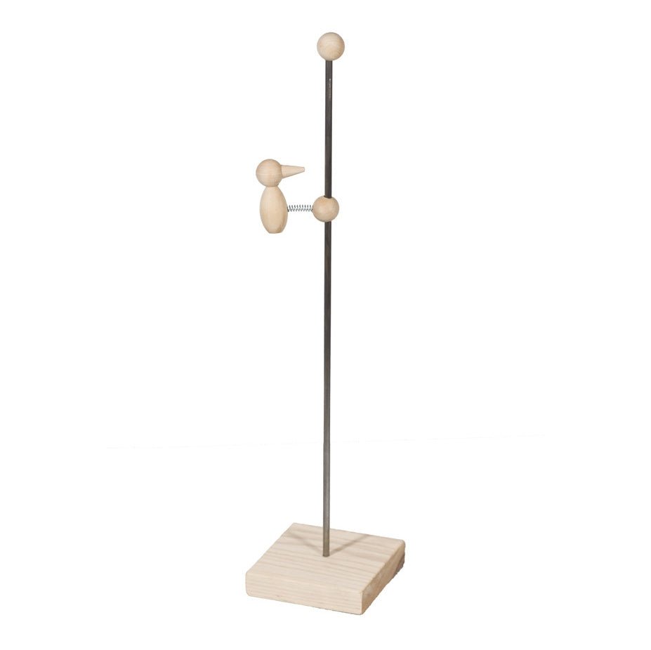 Wooden bouncing bird toy, a small carved bird on a spring riding a metal rod above a square wood base