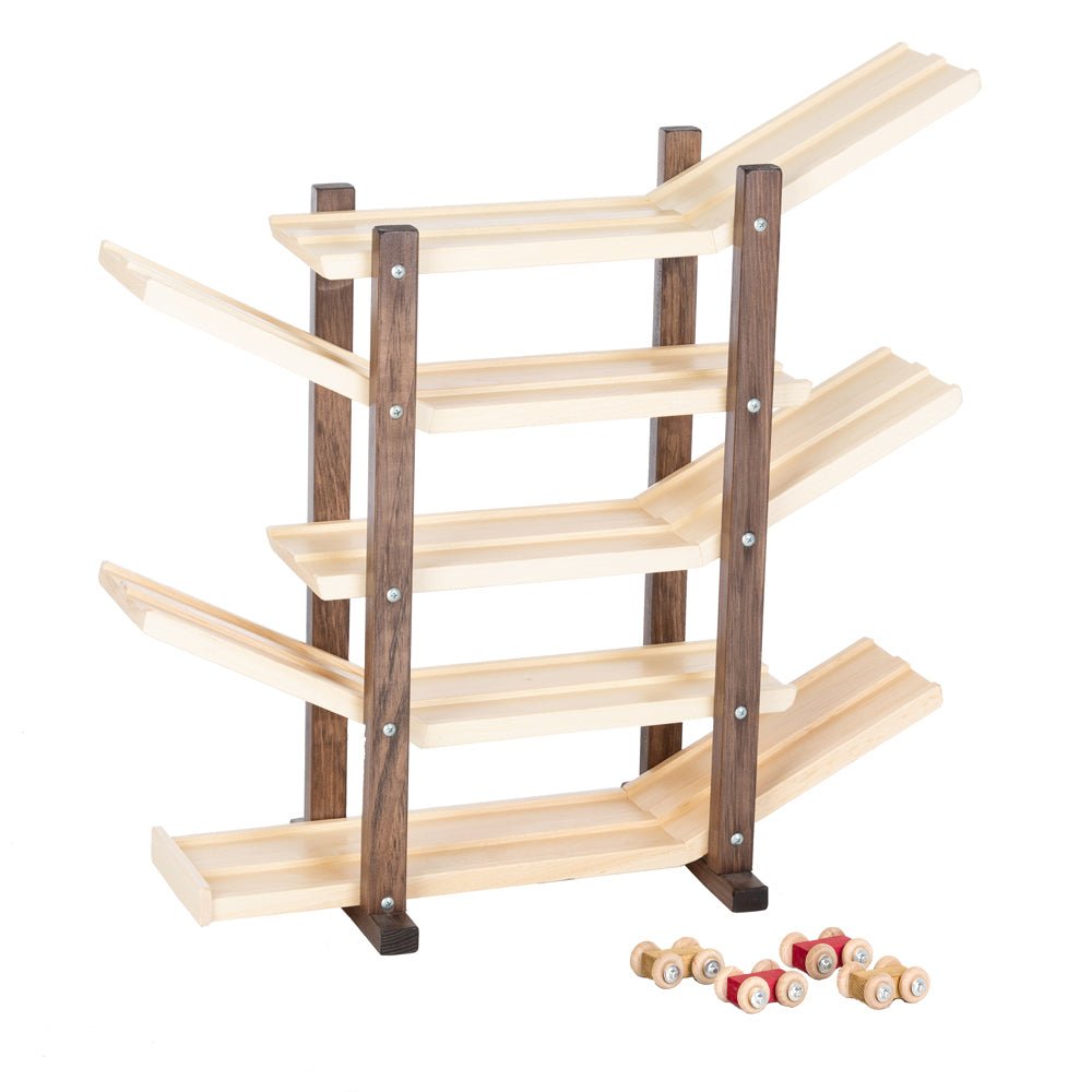 Light maple car roller racetrack with dark walnut posts, four sloping ramps and wooden cars beside it