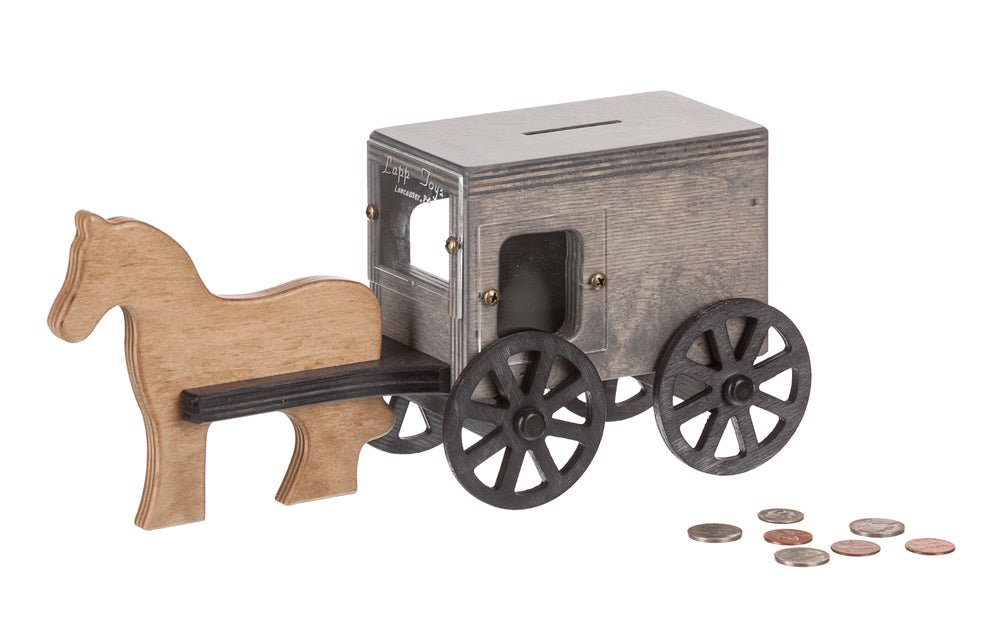 Wooden Amish horse and buggy coin bank in weathered gray with black spoked wheels and coins beside it