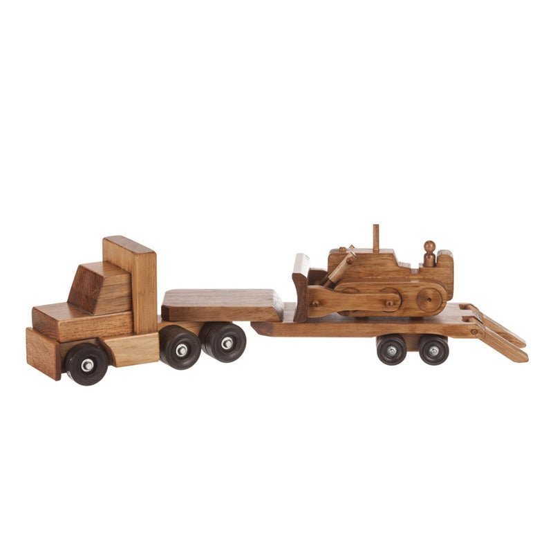 Toy wooden lowboy truck carrying a stained bulldozer with tracks and blade on its flatbed trailer with rear ramp