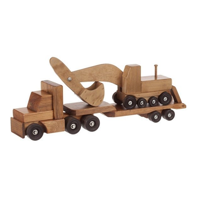 Stained wooden lowboy truck and trailer loaded with a toy excavator, its boom and bucket arched over the cab