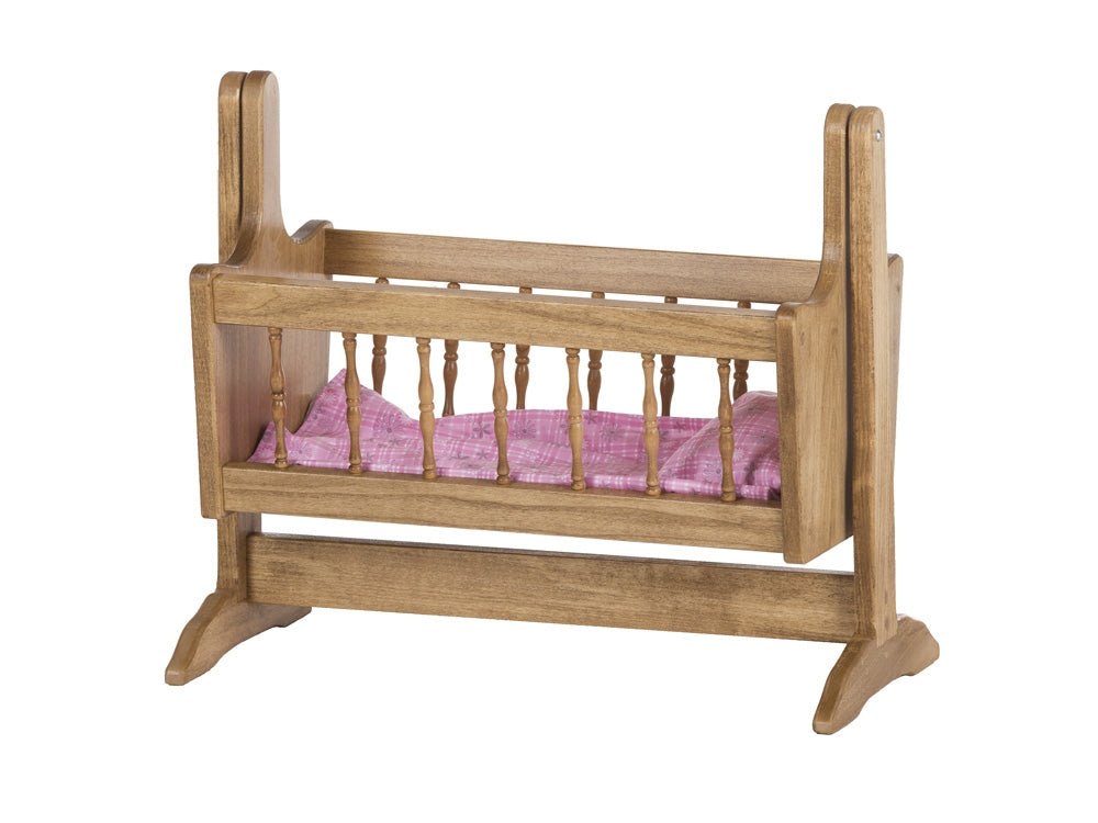 White painted swinging doll cradle with turned spindle sides, a chevron print mattress and a freestanding rocking frame