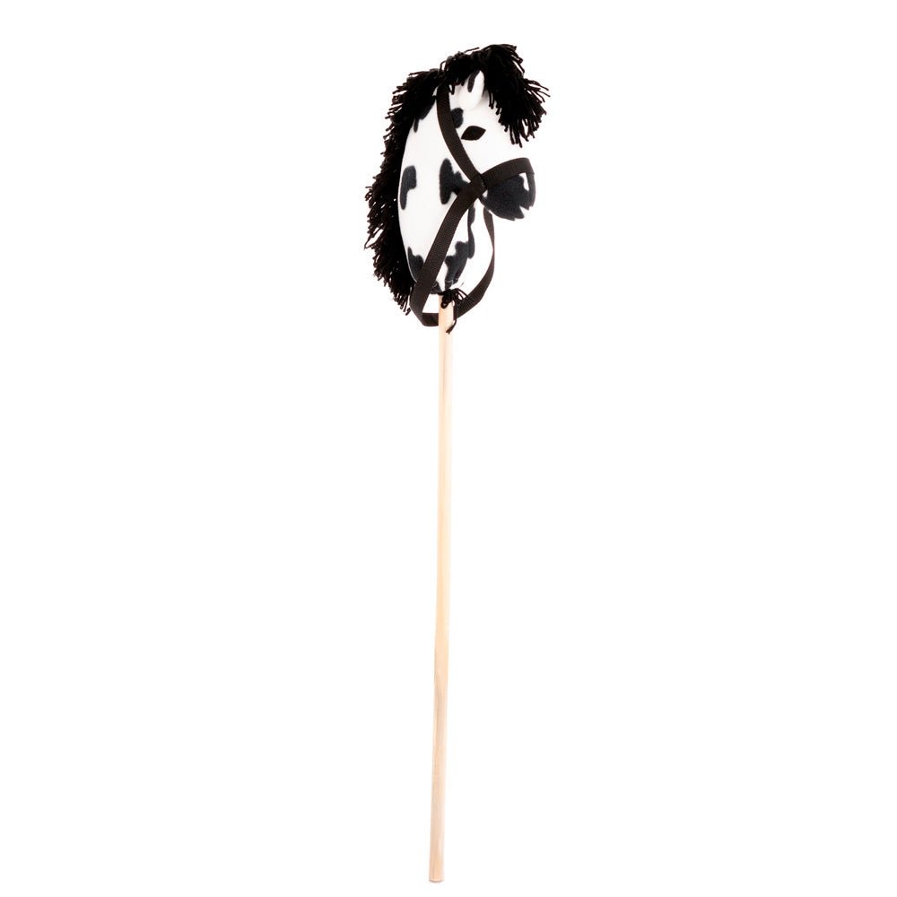 Black and white spotted plush stick horse with a shaggy black yarn mane, brown reins and wooden dowel