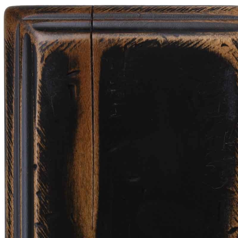 Close crop of the Antiquated Black maple sample, worn black paint with rub-through highlights, a hairline check and molded edge