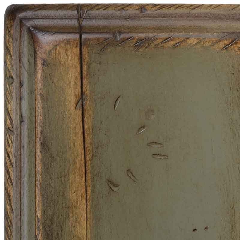 Green Frost antiqued sample corner, sage-olive painted face framed by rub-through brown molding and scattered distress dents