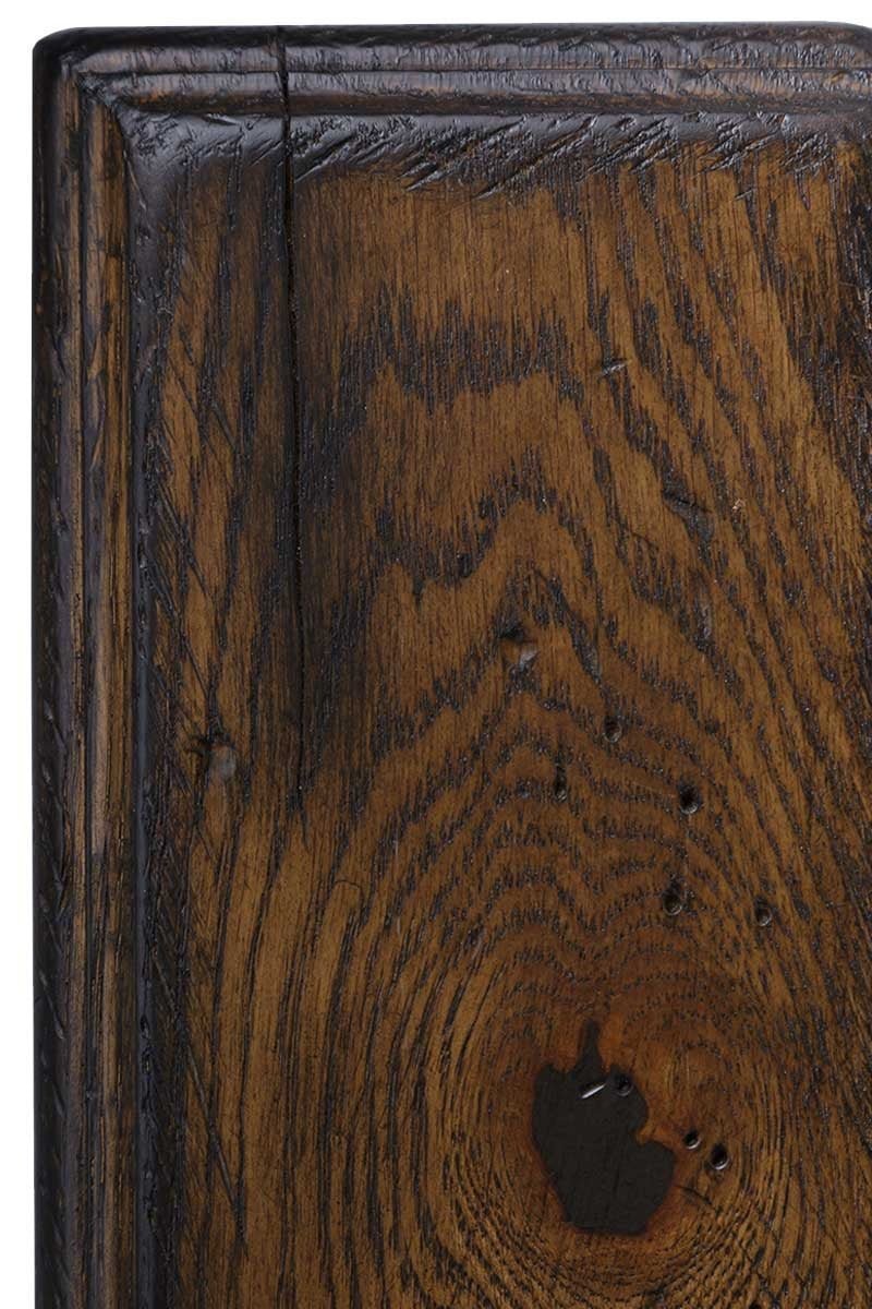 Antiquated Cappuccino on rustic oak, a golden brown panel with swirling grain, a black filled knot, worm holes and dark edges