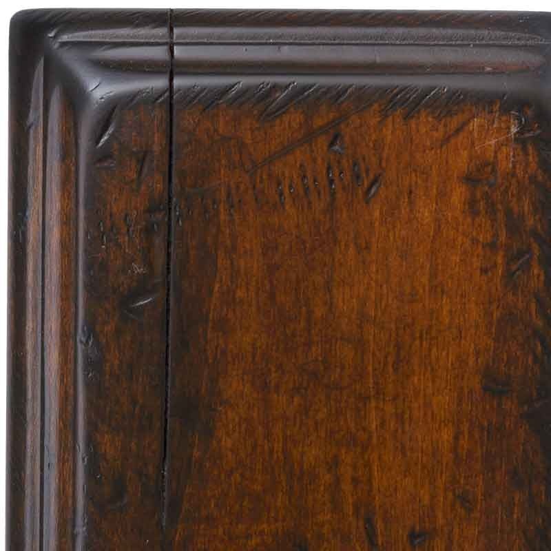 Michaels antiqued maple swatch corner, rich auburn stain with chiseled nicks along the rounded molding and a hairline check