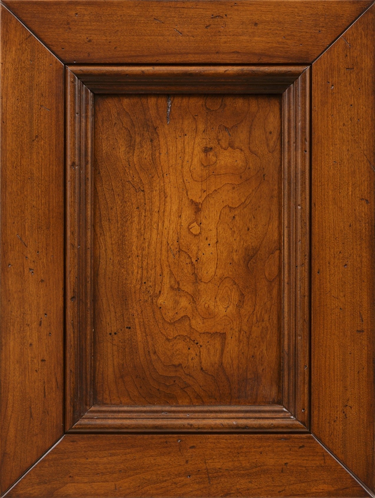 Cherry wood stain sample in a medium golden amber with figured grain and distress marks on a panel door