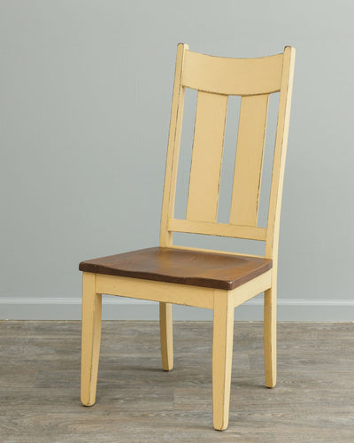 Buttercream painted dining chair with three tall back slats and a contrasting brown scooped wood seat