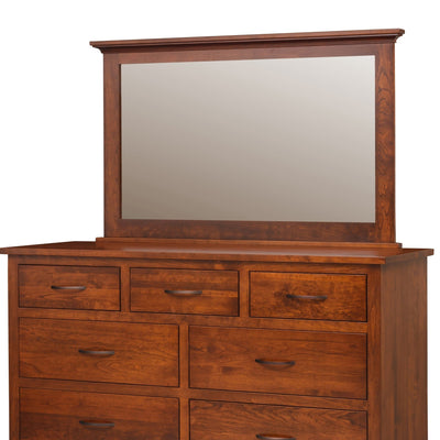 Close view of a wide cherry dresser mirror with molded crown top above three drawers with bronze pulls