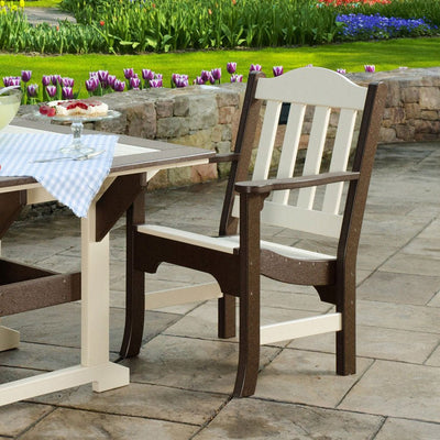 Ivory and brown poly garden armchair pulled up to a matching patio dining table beside tulip beds