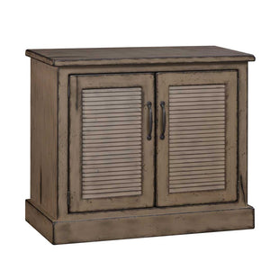 Distressed taupe gray two-door buffet with louvered door panels, dark bronze handles and molded plinth base