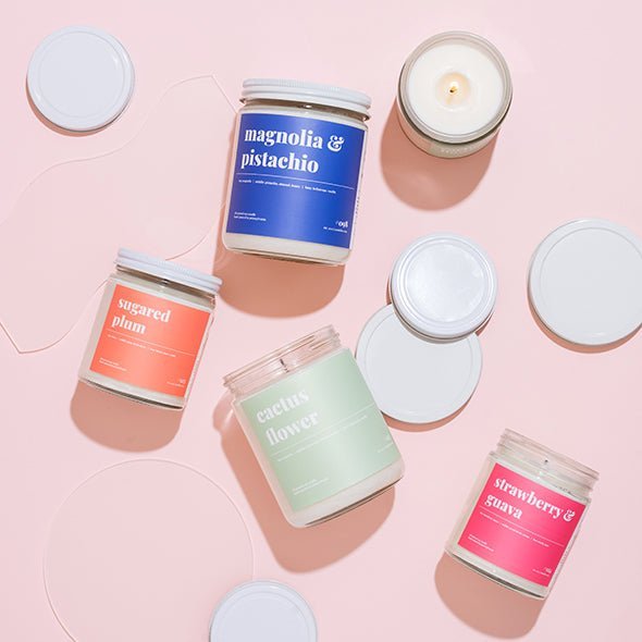 Assorted soy candles including cactus flower, sugared plum, magnolia and pistachio and strawberry guava on pink