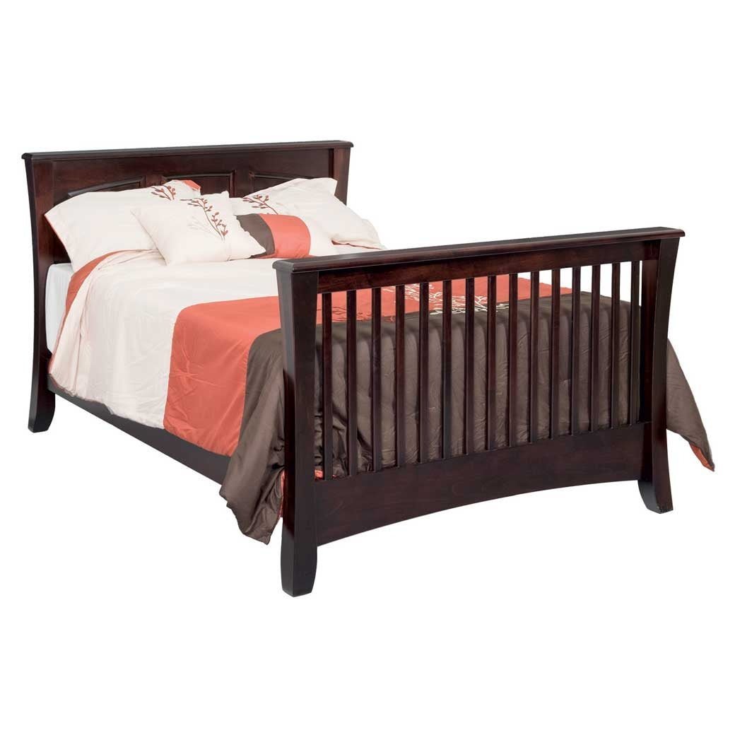 Espresso crib converted into a full size bed with slatted footboard, flared legs and coral and cream bedding