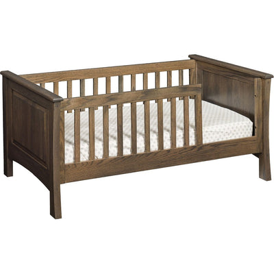 Weathered brown oak toddler bed with raised panel ends, slatted safety rails and a fitted crib mattress