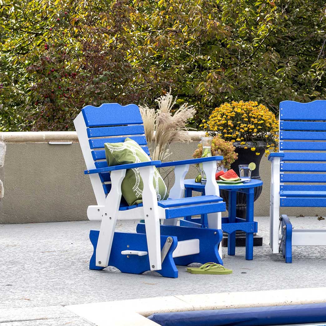 Blue and white poly curve back gliders with a matching round side table holding watermelon beside a pool