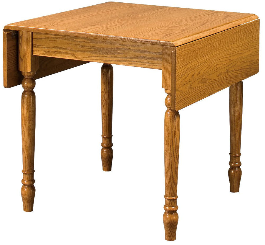 Oak drop leaf dinette table with both leaves lowered, showing turned legs and a golden oak finish