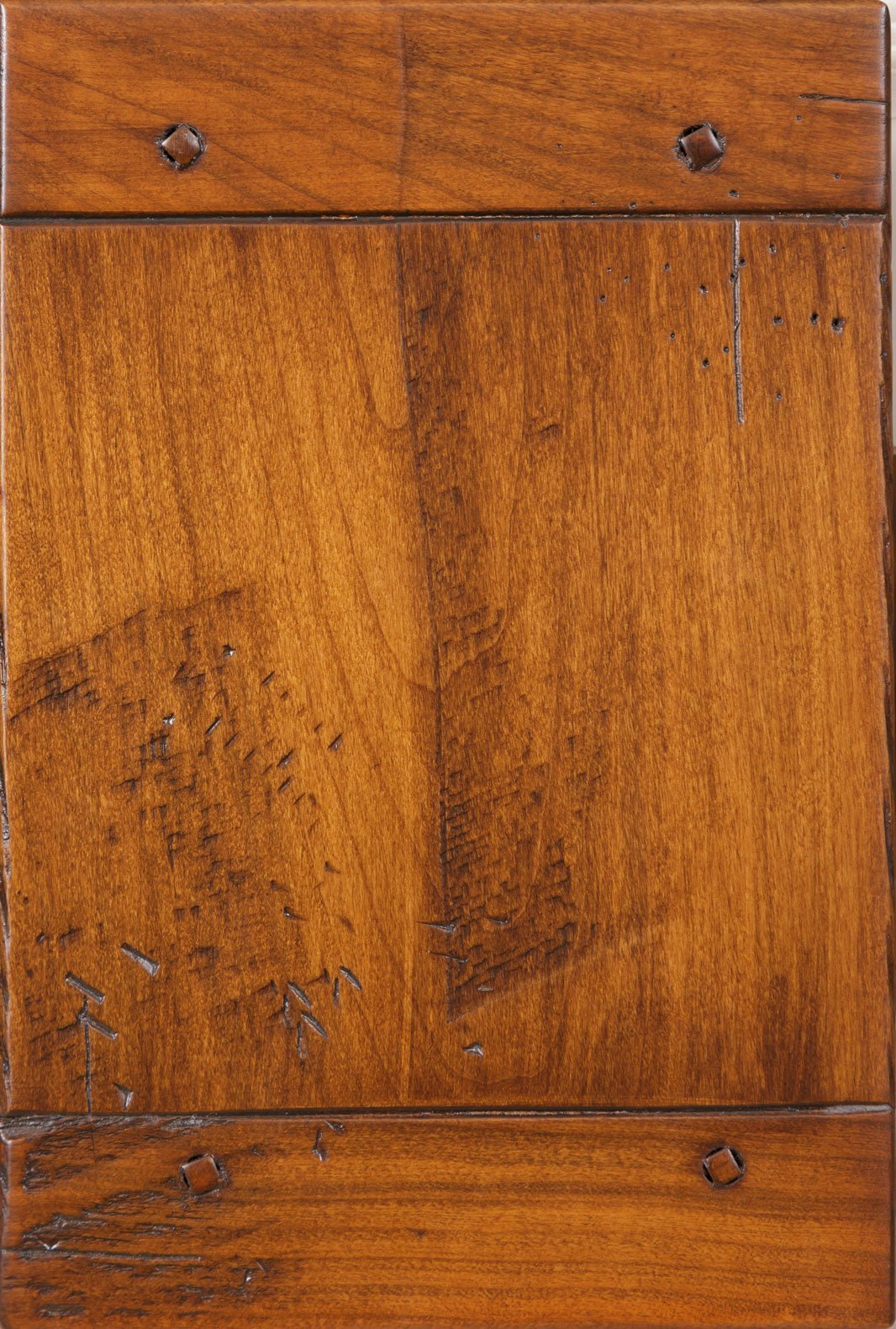 Driftwood stain on rustic cherry sample with distressed panel, worm marks, saw scratches and square peg accents in the rails