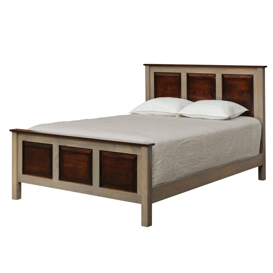Angled view of a gray framed panel bed with cherry raised panels, square posts and a low footboard on white