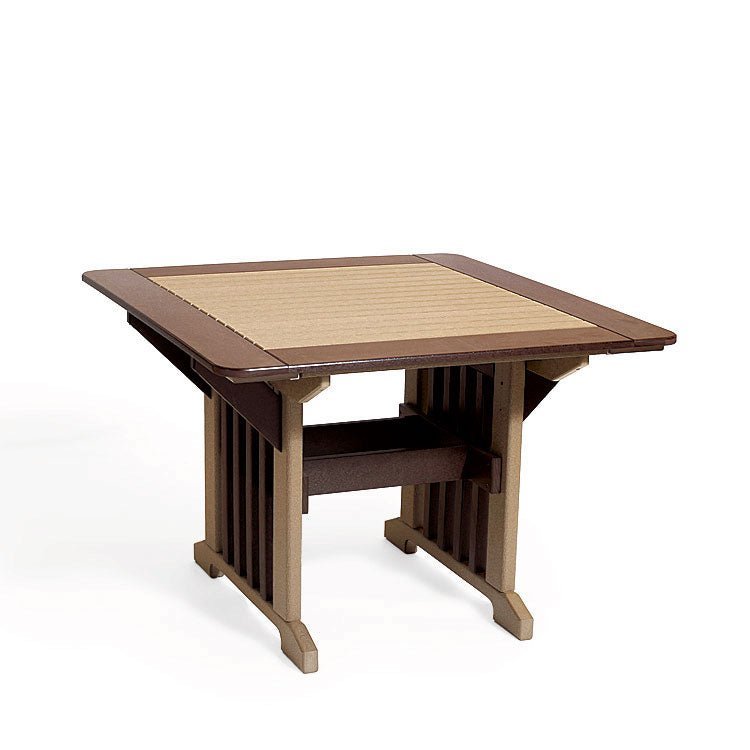 Weatherwood and cherry poly dining table for four under a pergola with tiki torch and barn in the background