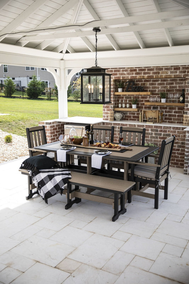 Overhead patio view of a weatherwood and black poly dining set with bench under a white pavilion with brick bar