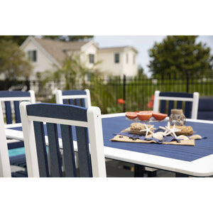 Close up of a navy and white poly patio dining table set with grapefruit halves, starfish and shells outdoors