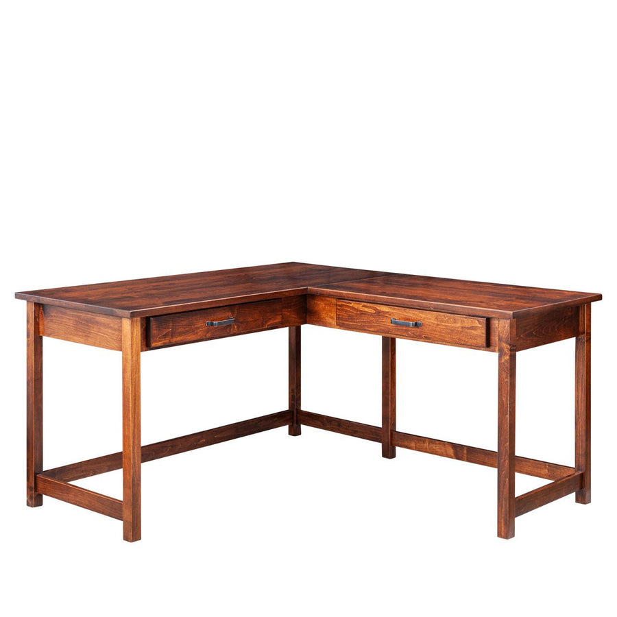L shaped table desk in warm brown wood with two drawers, black bar pulls and square legs joined by stretchers