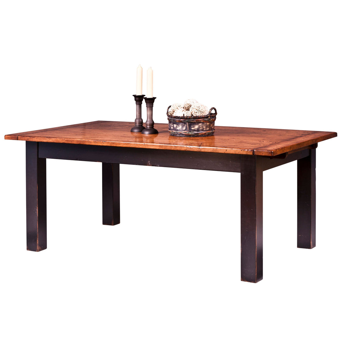 Farmhouse dining table with a distressed pine plank top and black painted square legs, styled with candles and a basket