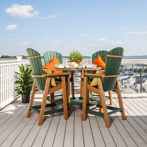 Green and cedar poly round bar table with four fan back Adirondack bar chairs and orange pillows on a marina deck