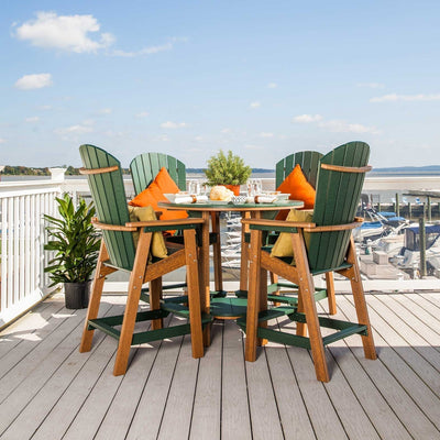 Green and cedar poly round bar table with four fan back Adirondack bar chairs and orange pillows on a marina deck
