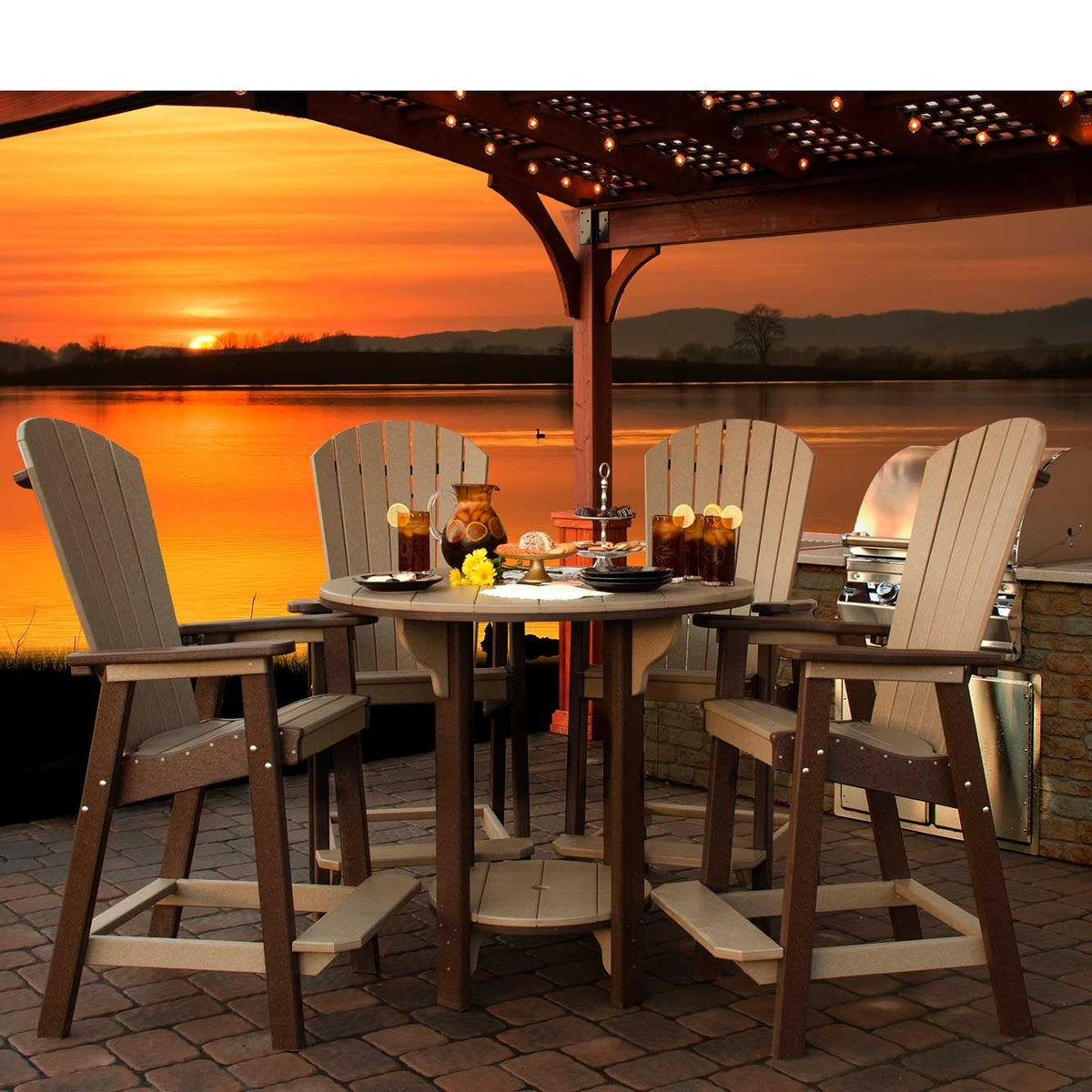 Weatherwood and brown poly bar table set with four Adirondack bar chairs and iced tea under a pergola at sunset