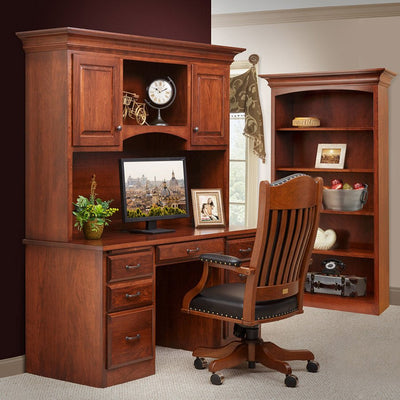 Cherry double pedestal desk with hutch, leather office chair and matching bookcase in a burgundy walled office