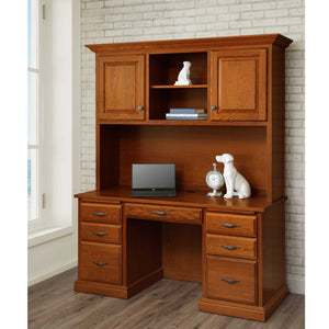 Oak computer desk with hutch, six drawers and paneled upper cabinets, styled with a laptop by a brick wall